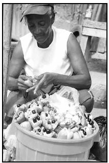 Ludel Gordon prepares ackee to sell in the Papine market in Kingston, Jamaica. Sauteed like a vegetable, the golden flesh of the ackee resembles scrambled eggs. When dried and salted codfish is added, the national dish of Jamaica, ackee and saltfish, results. When served for breakfast, it is accompanied by bammy, a fried biscuit made from ground cassava and plantains. AP Photo/Collin Reid