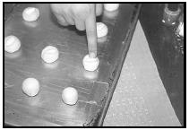 To make Almond Cookies, press a whole almond into the center of each dough ball. EPD Photos