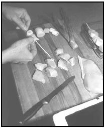 Thread pieces of chicken and slices of leek onto bamboo skewers. The skewers should be soaked in water for at least thirty minutes before using. EPD Photos
