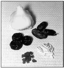 Garlic, dates, almonds, apricots, and prunes (clockwise from top) are added to rice and ground meat (usually lamb) to make plov, or Kazakh rice pilaf. EPD Photos